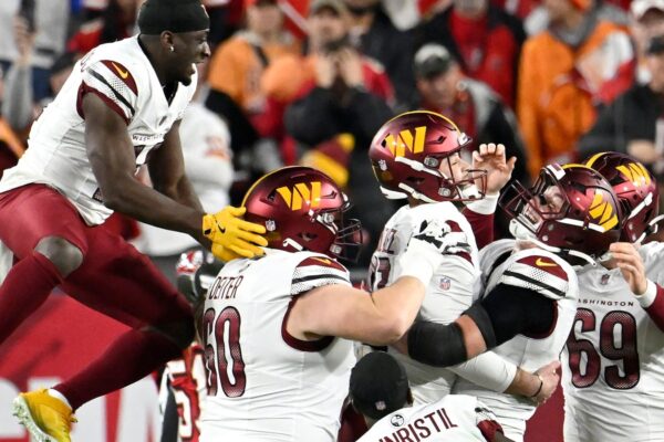 Washington Commanders place kicker Zane Gonzalez, middle, is congratulated by teammates after kicking the game winning field goal against the Tampa Bay Buccaneers during the second half of an NFL wild-card playoff football game in Tampa, Fla., Sunday, Jan. 12, 2025. (AP Photo/Jason Behnken)