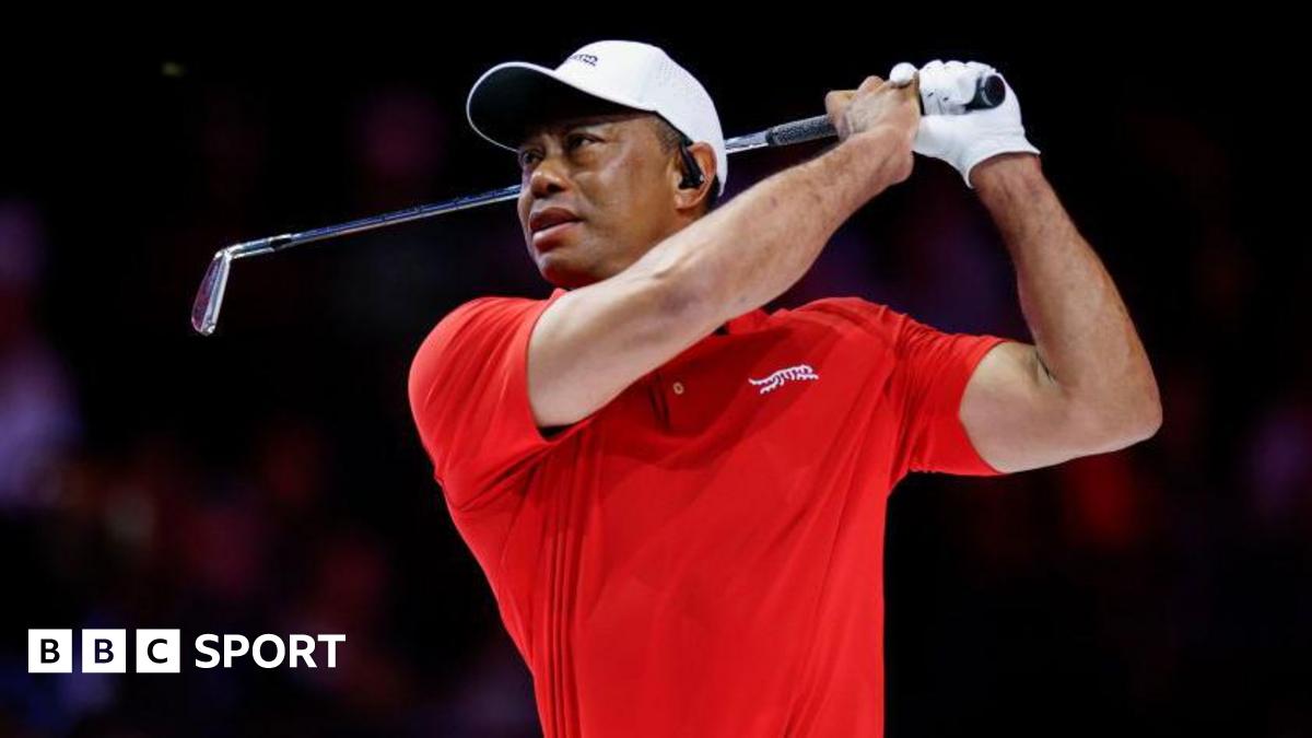 Tiger Woods watches his ball after an iron shot