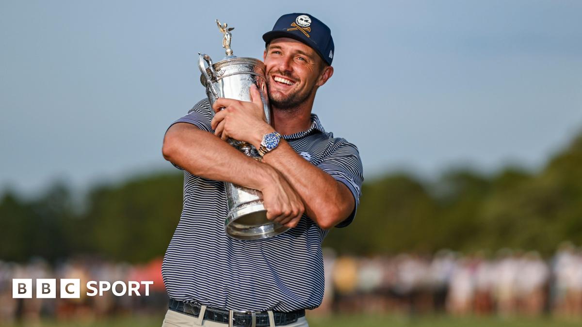 Bryson DeChambeau holds up the 2024 US Open trophy