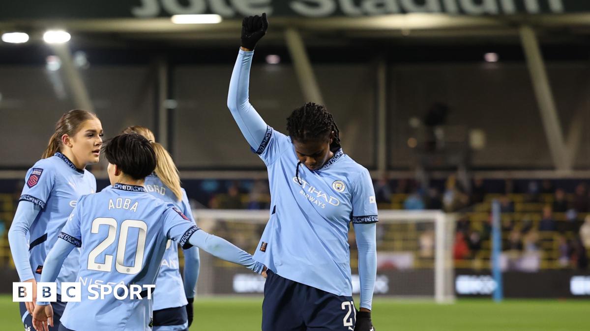 Khadija Shaw raises one arm and bows her head after scoring