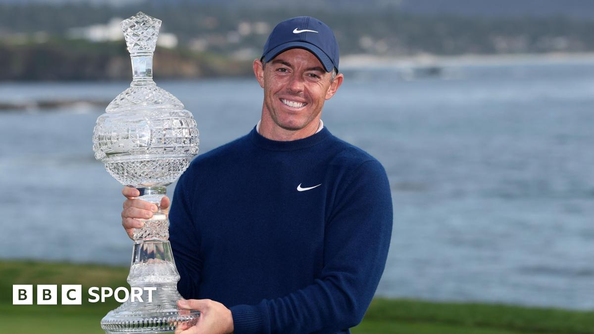 Rory McIlroy poses with the Pebble Beach Pro-Am trophy