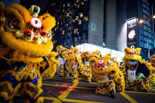 HONG KONG - FEBRUARY 19:  Performers dance at the 2015 Cathay Pacific International Chinese New Year Night Parade on February 19, 2015 in Hong Kong, Hong Kong. The parade featured illuminated floats accompanied by local and international performing groups which entertained both locals and tourists alike on Chinese Lunar New Year. Tens of thousands gathered in Hong Kong today to celebrate the Chinese New Year and welcome the Year of the Goat, with New Year