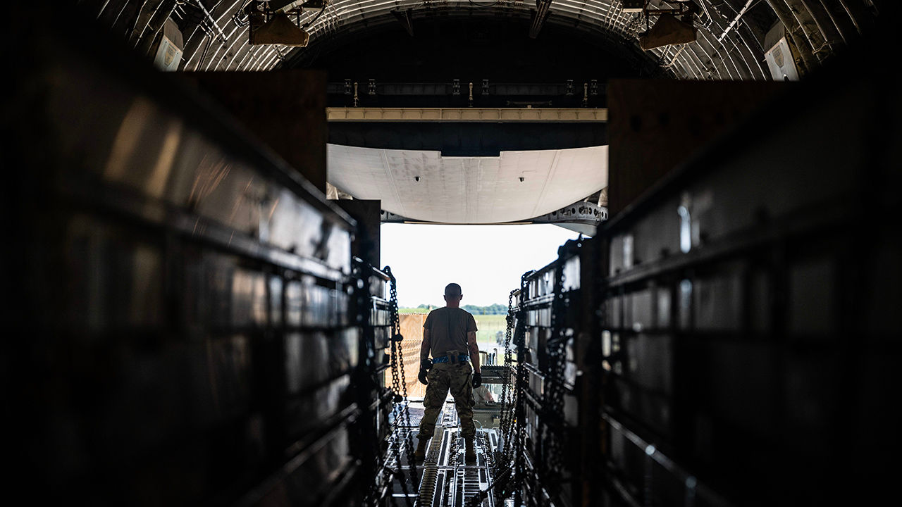 A Team Dover Airman loads weapons cargo bound for Ukraine onto a C-17 Globemaster III during a security assistance mission at Dover Air Force Base, Delaware