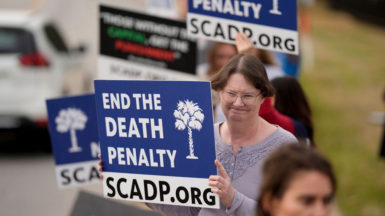 Vivian Lovingood protests the scheduled execution of South Carolina inmate Brad Sigmon, Friday, March 7, 2025, in Columbia, S.C. For the first time in 15 years a death row inmate in the U.S. will be executed by a firing squad. (AP Photo/Chris Carlson)