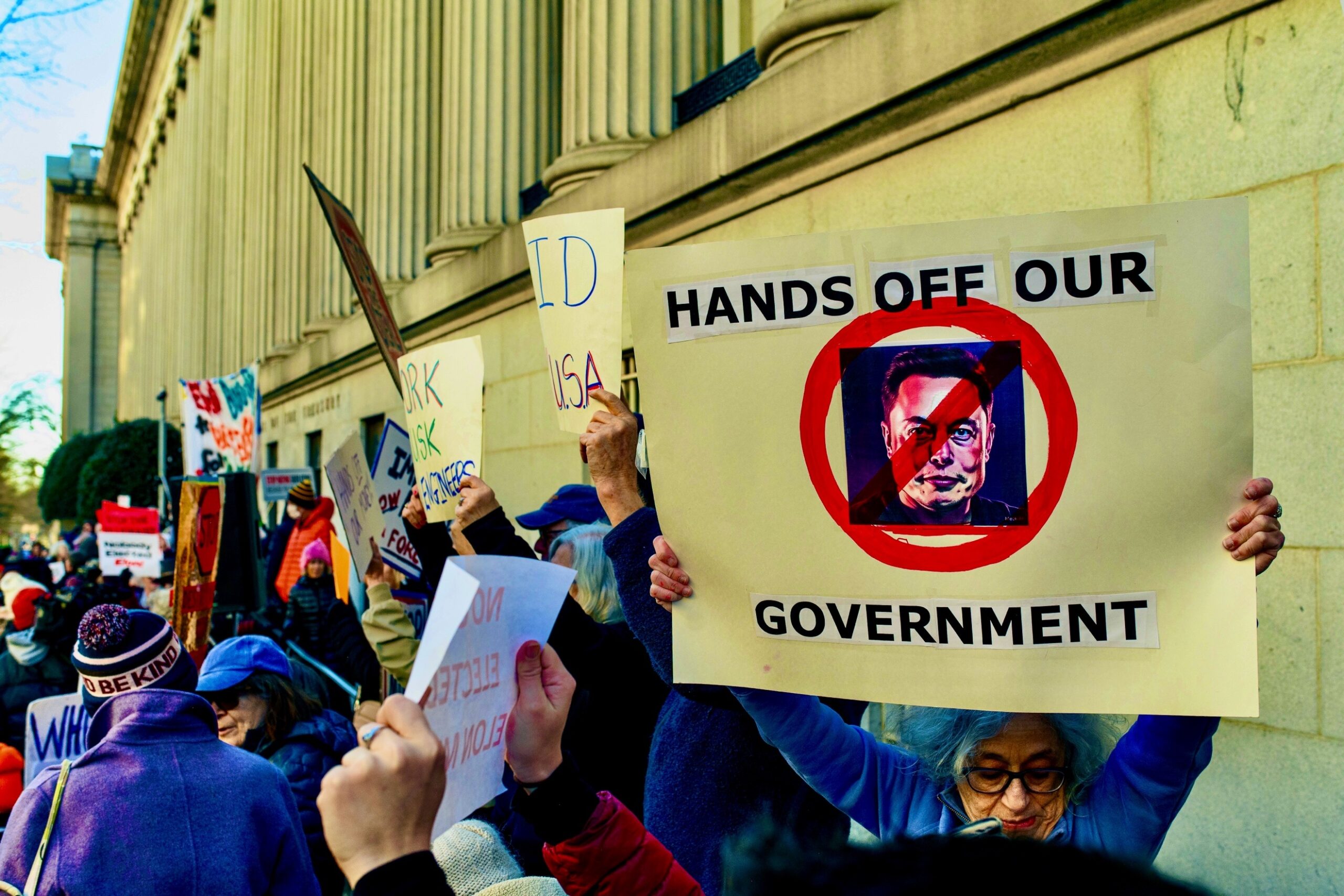 A group of people holding signs AI-generated content may be incorrect.