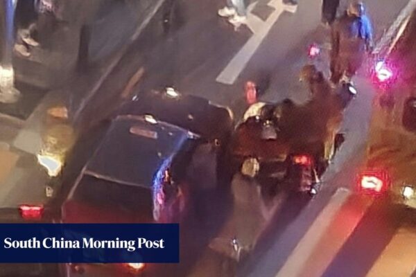 Pedestrians help to lift taxi after Hong Kong girl’s leg trapped in accident