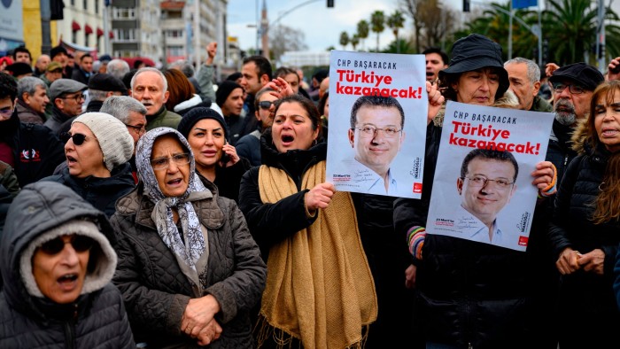 Supporters of the Mayor of Istanbul demonstrate in front of the Turkish police barricade against his detention over a corruption probe in Istanbul