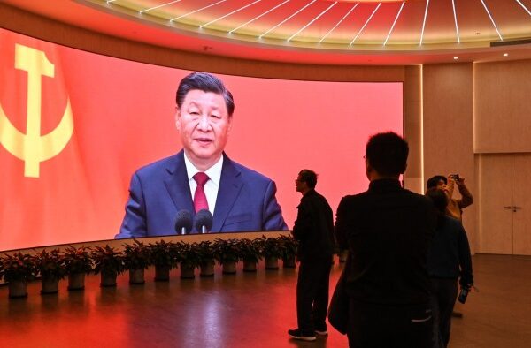 A screen shows images of China’s President Xi Jinping as people visit the Museum of the First National Congress of the Chinese Communist Party in Shanghai