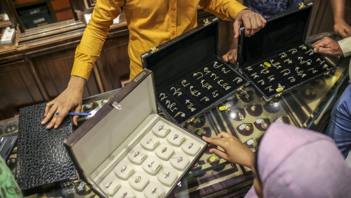 People look at rings in a jewellery store