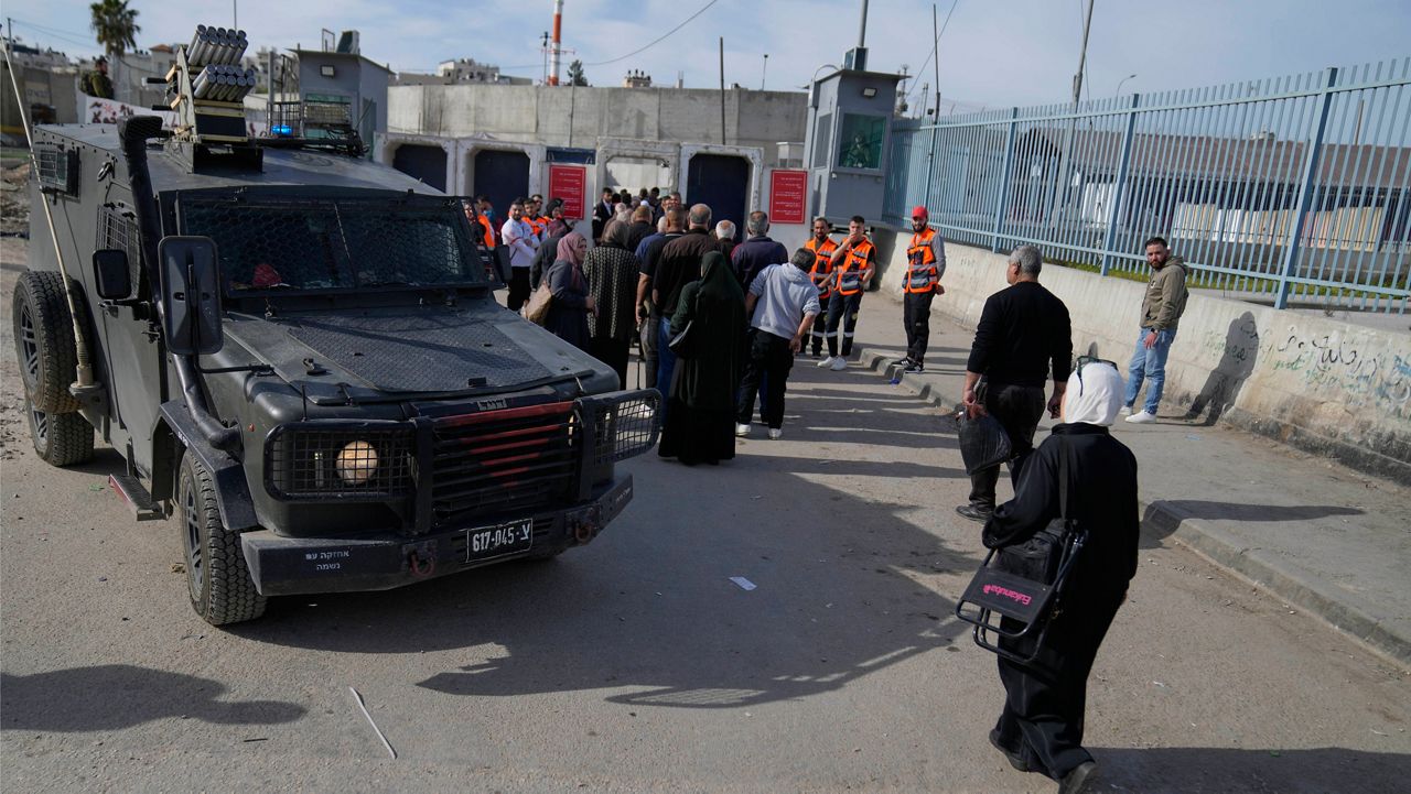 Palestinians cross from the Israeli military Qalandia checkpoint near the West Bank city of Ramallah to Jerusalem, to participate in the Friday prayers at the Al-Aqsa Mosque compound during the Muslim holy month of Ramadan on Friday, March 14, 2025. (AP Photo/Nasser Nasser)