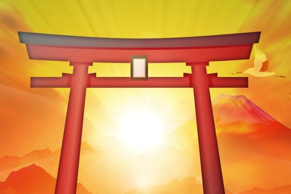 Torii gate with a mountain looming in the background and sun rays shining through