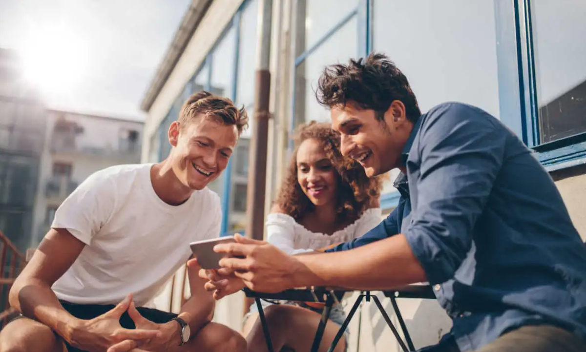 three people viewing mobile app