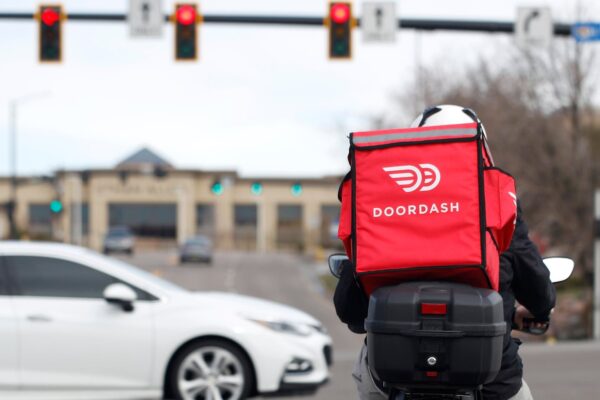 DoorDash driver pictured waiting at a traffic light.