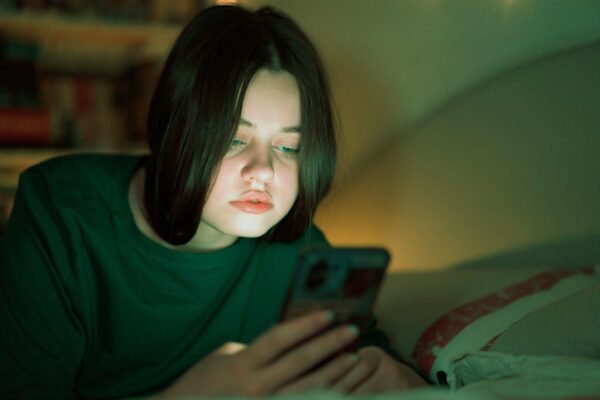 Chinese marketplace DHgate becomes a top US app as trade war intensifies Portrait of a teenage girl looking at her mobile phone.