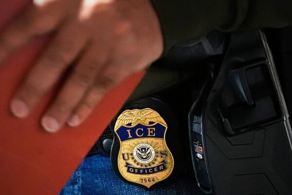A deportation officer with Enforcement and Removal Operations in U.S. Immigration and Customs Enforcement's New York City field office conducts a brief before an early morning operation, Tuesday, Dec. 17, 2024. (AP Photo/Julia Demaree Nikhinson, File)