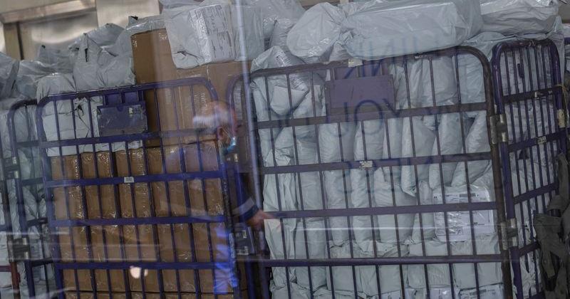 FILE PHOTO: Parcels await processing in a post office, as Hong Kong Post stops certain U.S.-bound shipments since April 27 due to new U.S. tariff rules, in Hong Kong | U.S. & World