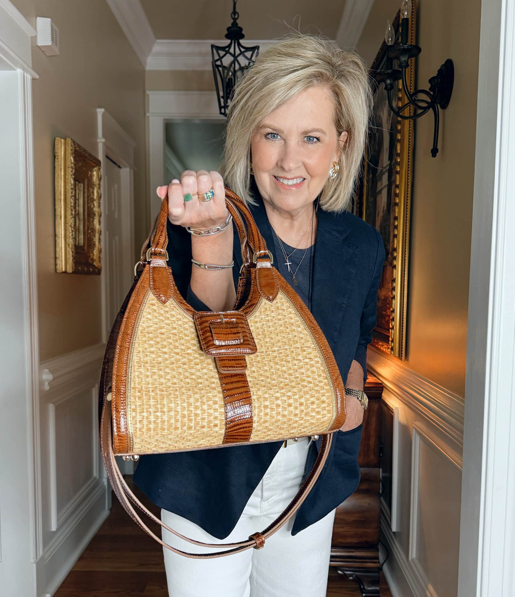 woman holding a Brahmin handbag from Belk