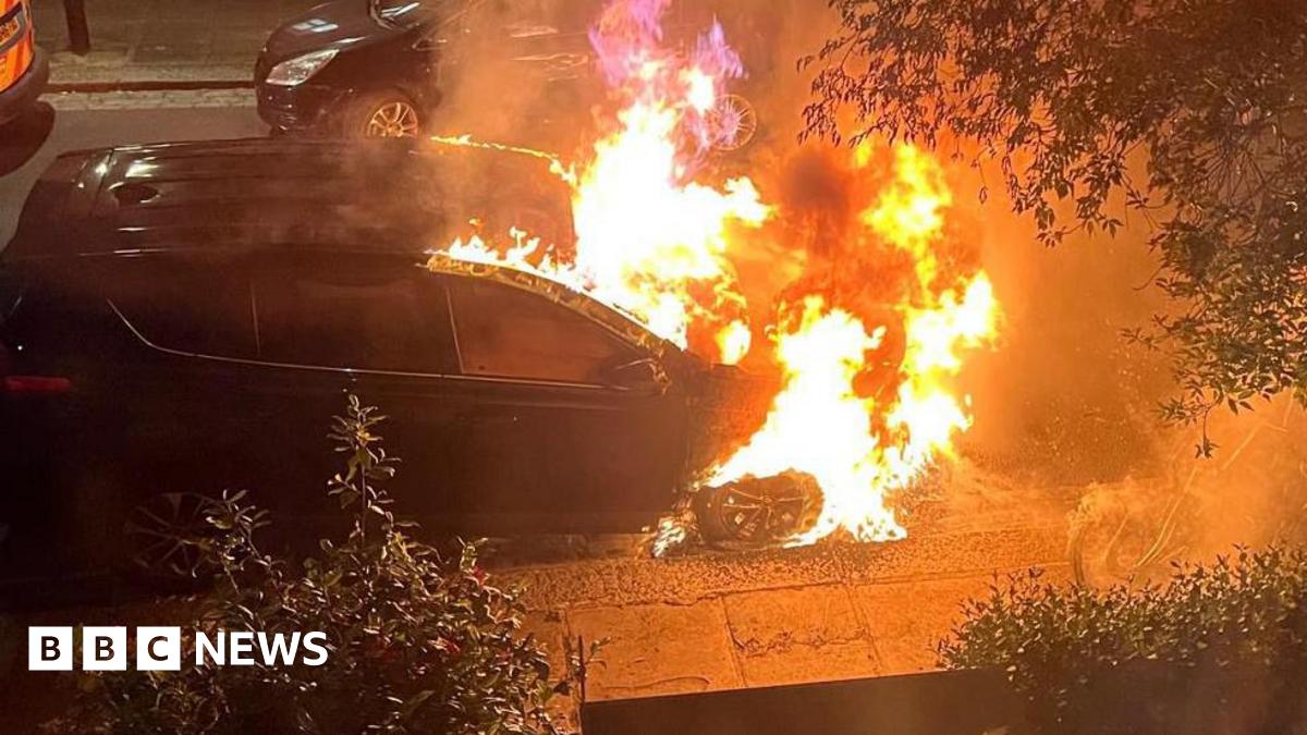 A still from a video showing a car on fire