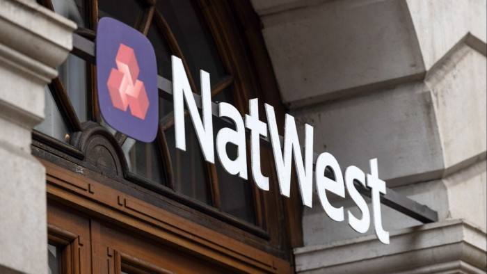 A sign outside the entrance to a NatWest  bank branch in London