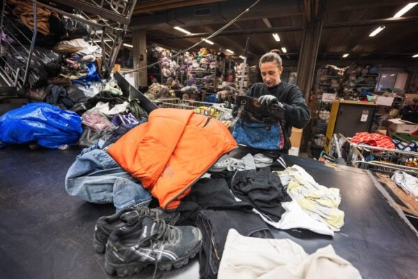 Fashion brands face growing EU pressure to cut textiles waste A worker sorts incoming clothing items at a sorting centre overflowing with clothes