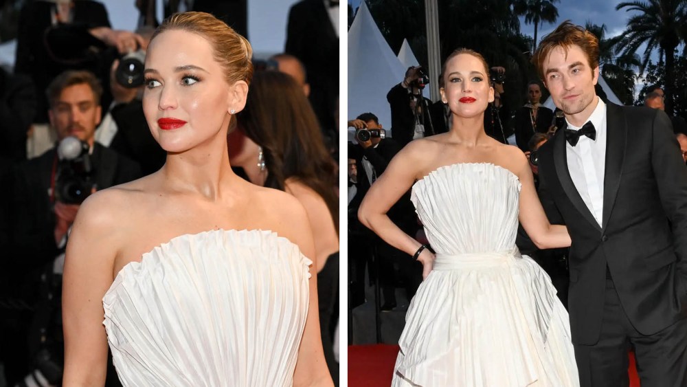 Jennifer Lawrence wears dior fan dress, Robert Pattinson at the "Die, My Love" Premiere during the 78th Cannes Film Festival held at Palais des Festivals on May 17, 2025 in Cannes, France.