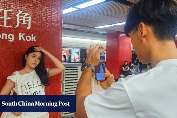 Why are mainland Chinese tourists posing in front of MTR stations in Hong Kong?