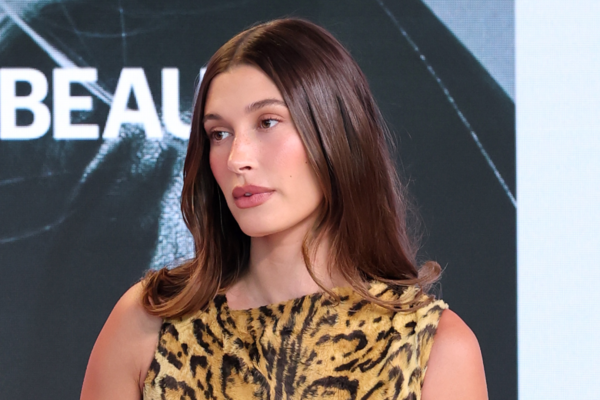 Hailey Bieber attends the Business of Beauty Global Forum in a vintage Versace leopard print dress.