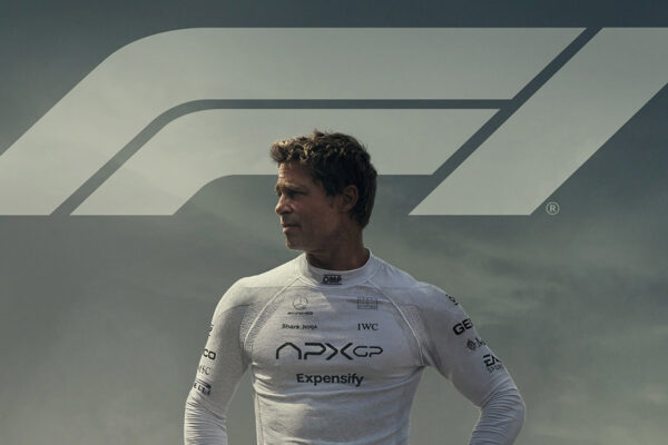 Brad Pitt looks over his right shoulder with 'F1' written behind him
