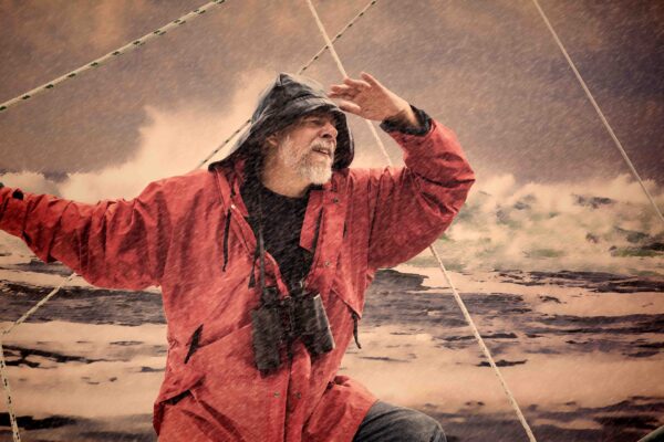 an older man on a boat in a storm