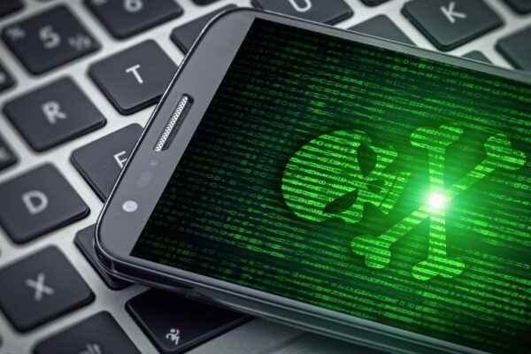 Green skull on smartphone screen.