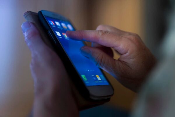Senior hand holding smartphone