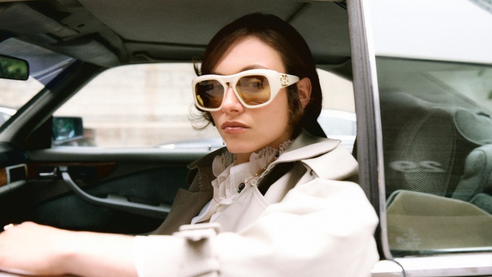 McQueen cotton gabardine trenchcoat and piqué polo shirt; Tommy Hilfiger crinkle silk-blend shirt; Valentino sunglasses; Zimmermann necklace with 12-karat gold brass detailing, natural Tiger’s Eye, Green Quartz Lapiz, Aquamarine and Freshwater Pearl stones.A