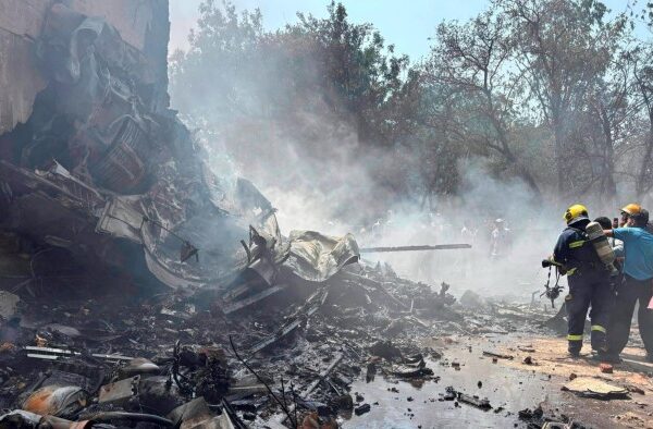 Firefighters battle to extinguish burning wreckage at the site of the plane crash in Ahmedabad on Thursday
