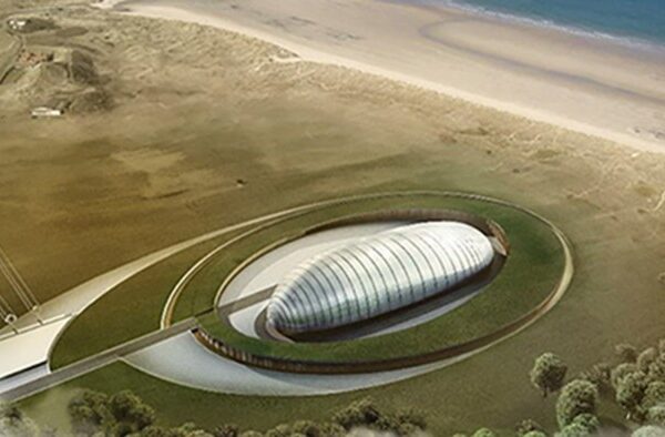 Aerial view of a proposed small modular reactor facility, featuring a modern, oval-shaped building