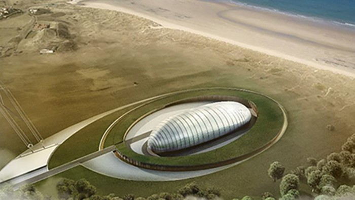 Aerial view of a proposed small modular reactor facility, featuring a modern, oval-shaped building