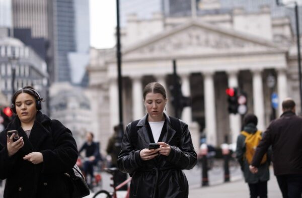 Commuters walk in City of London financial district