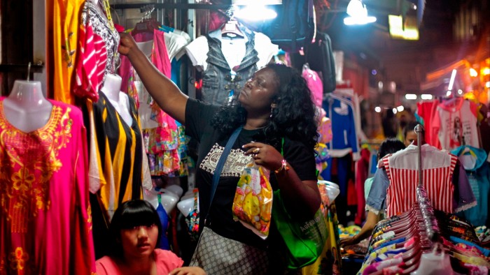 An African woman shops at a market at ‘African village’ in Guangzhou,