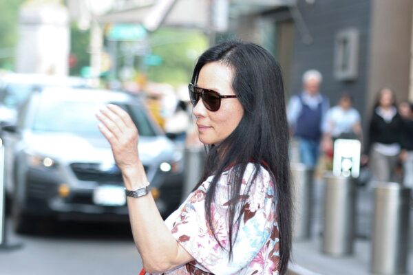 Lucy Liu wearing a floral dress and sunglasses