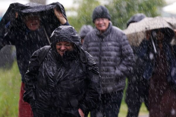 Spectators got caught out in a heavy rain shower at the Lexus Birmingham Open at Edgbaston Priory Club, Birmingham. Pic: PA