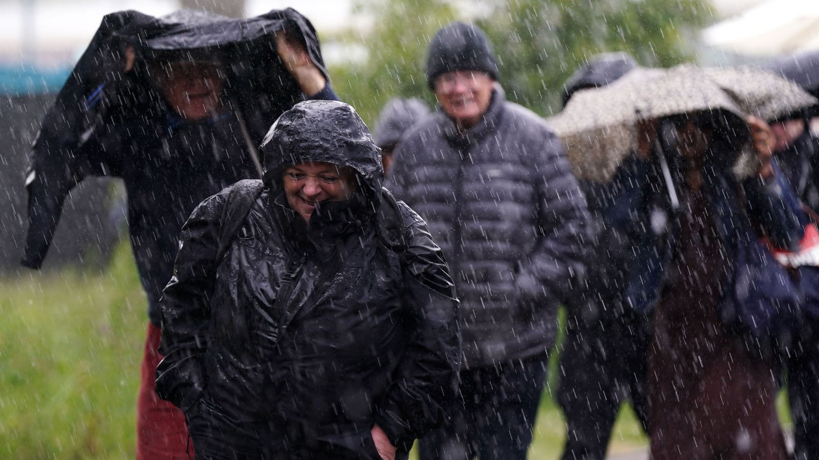 Spectators got caught out in a heavy rain shower at the Lexus Birmingham Open at Edgbaston Priory Club, Birmingham. Pic: PA