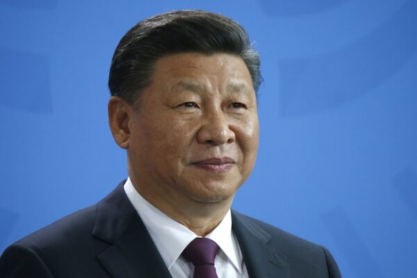 Chinese President Xi Jinping against a blue background.