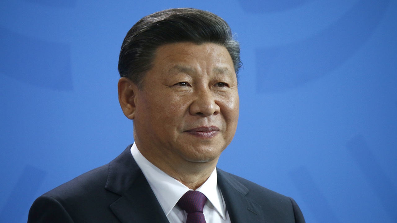Chinese President Xi Jinping against a blue background.