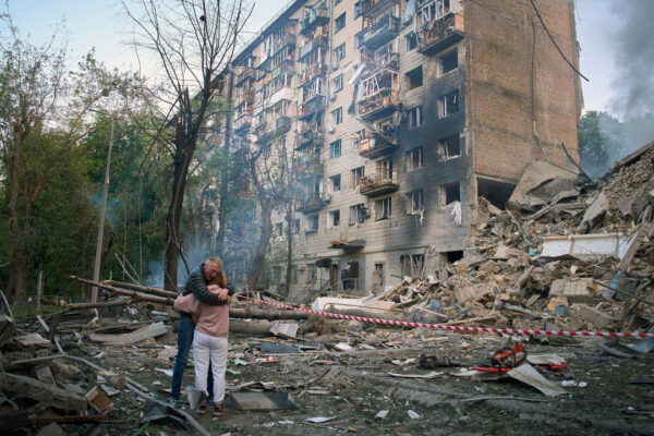 Residents embrace after a Russian missile hit a multi-storey apartment