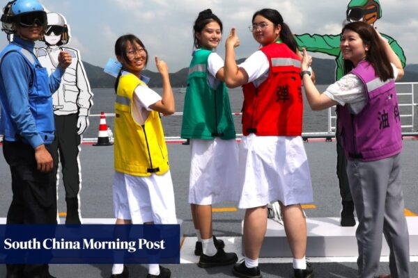 Aircraft carrier ‘rainbow-men’ add splash of colour to Hong Kong pupils’ visit