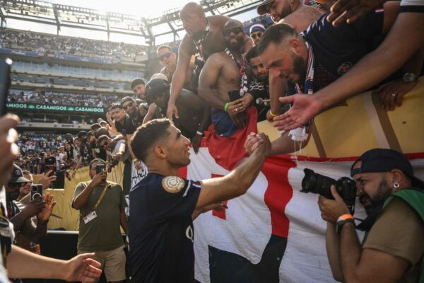 Achraf Hakimi of Paris Saint-Germain celebrates with fans at the end of the Club World Cup semi-final win over Real Madrid.