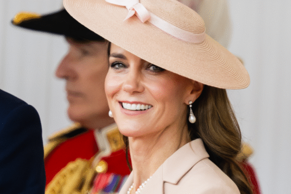 Princess Kate wearing a pink hat with a bow smiling