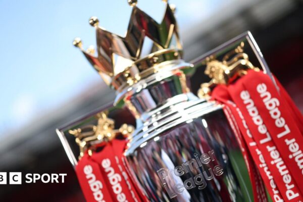 The Premier League trophy dressed in red ribbons