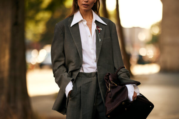 woman wearing grey suit, white button down shirt