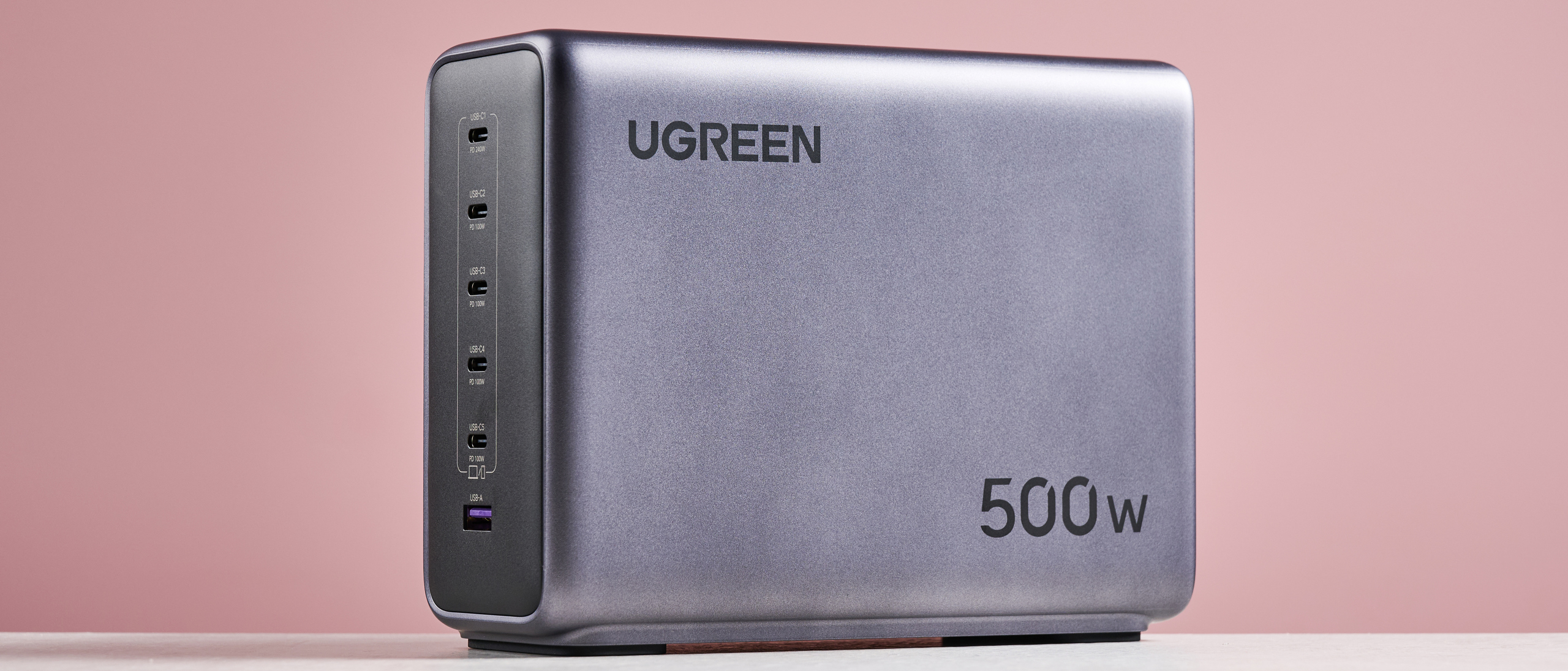 UGreen Nexode 500W 6-Port Charger against pink background