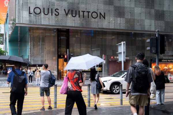 Pedestrians near a Louis Vuitton store in Hong Kong